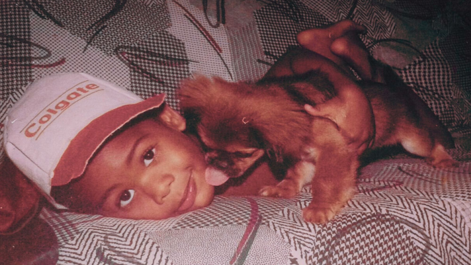 Axel Girier as a child in the 90's, playing on the family couch with his first dog, Fifi.